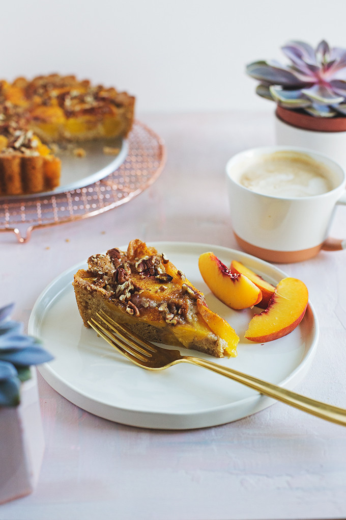 Brown Sugar Peach Buckle - this easy summer cake envelopes sweet peaches with a rich brown sugar and brown butter cake batter that's sprinkled with toasty pecans. 