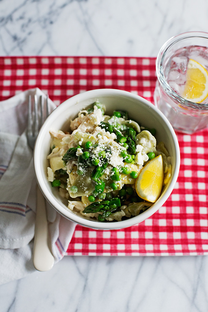 Spring Chicken Pasta Salad--A creamy, yet bright, spring pasta salad with zesty lemon, fresh asparagus, sweet peas, hearty chicken, salty feta, and bright herbs.