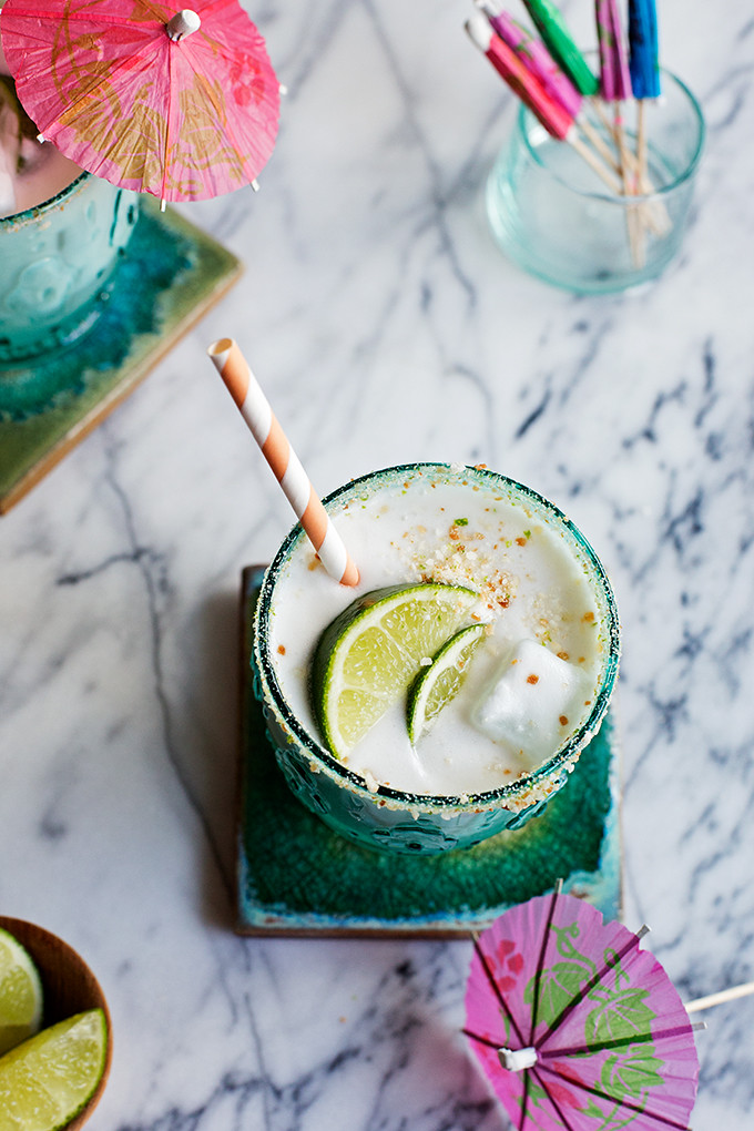 Creamy Coconut Margaritas--this margarita has all the usual suspects like lots of lime and tequila, plus a creamy coconut base and a salty toasted coconut and lime sugar rim! 