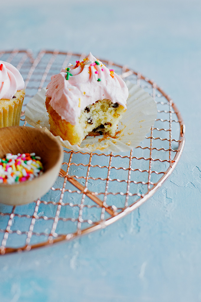 Chocolate Chip Cupcakes with Cream Cheese Frosting | One dozen, fluffy, chocolate chip studded cupcakes with tangy cream cheese frosting and plenty of sprinkles. 