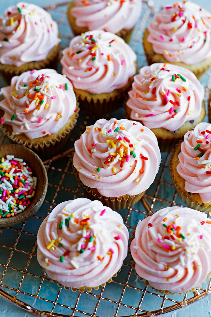 Chocolate Chip Cupcakes with Cream Cheese Frosting | One dozen, fluffy, chocolate chip studded cupcakes with tangy cream cheese frosting and plenty of sprinkles. 