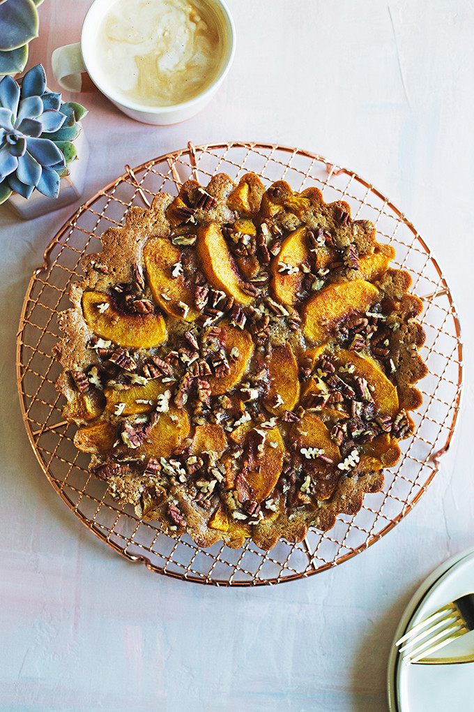 Brown Sugar Peach Buckle - this easy summer cake envelopes sweet peaches with a rich brown sugar and brown butter cake batter that's sprinkled with toasty pecans. 