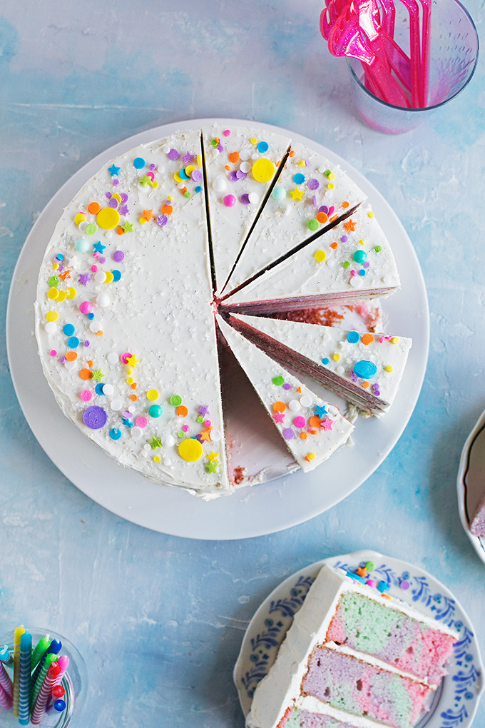 Rainbow Marble Layer Cake - A festive cake with rainbow marbled vanilla bean + buttermilk cake layers frosted with swirls of silky vanilla bean swiss meringue buttercream. 