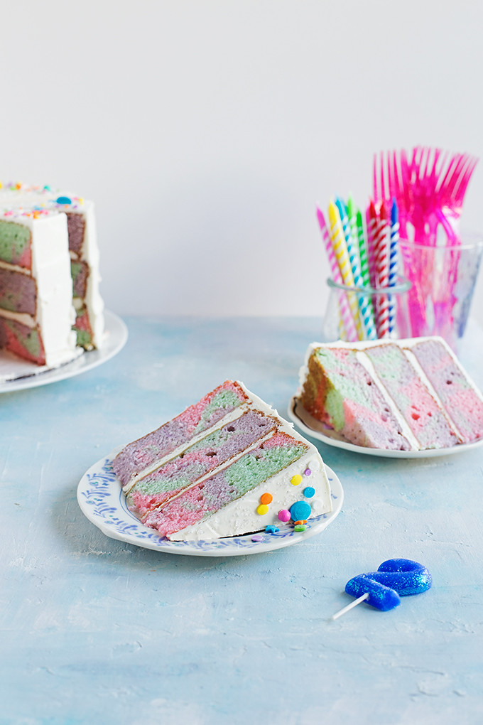 Rainbow Marble Layer Cake - A festive cake with rainbow marbled vanilla bean + buttermilk cake layers frosted with swirls of silky vanilla bean swiss meringue buttercream. 